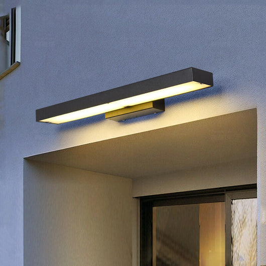 Linear LED outdoor sconce lighting a modern facade at night