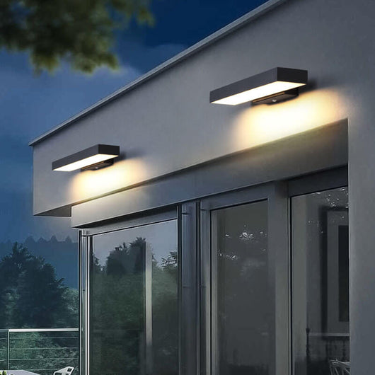 Black flat rectangular motion sensor outdoor wall light mounted on an exterior wall