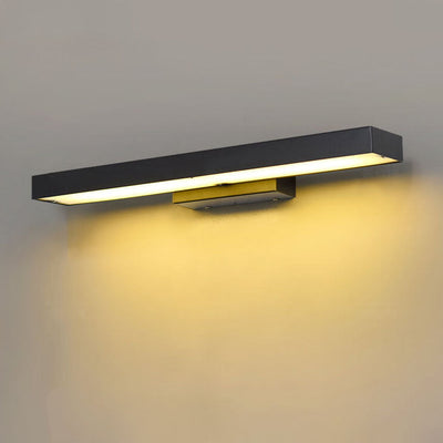 Outdoor wall light casting a wide warm band of light across a wall