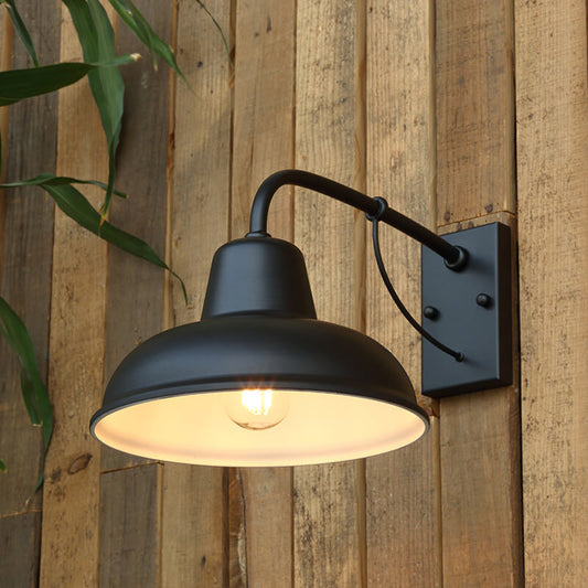 Black gooseneck barn wall light mounted on exterior wall