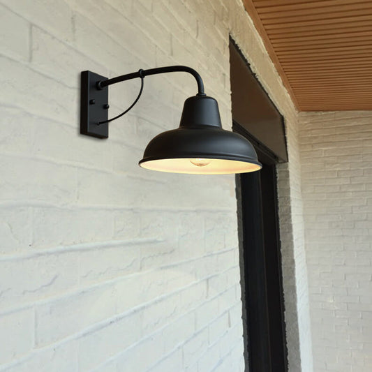 Black iron gooseneck barn light shade and curved arm detail