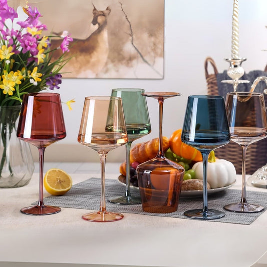 Colorful wine glasses set on a styled dinner table