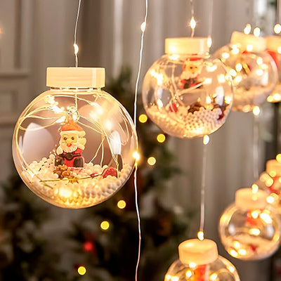 Clear Christmas light balls with snow and pine cones