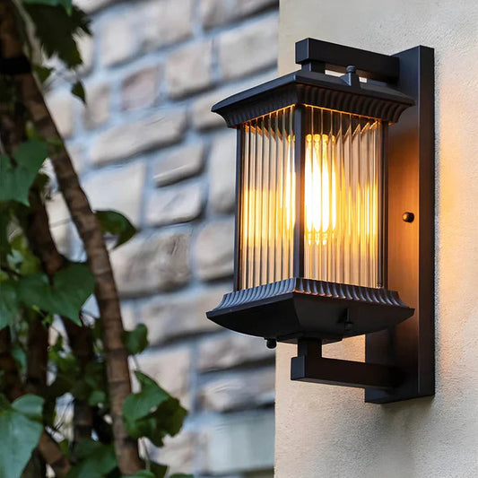 Traditional lantern wall light lit on an exterior brick wall