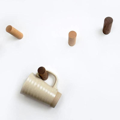 Brown finish timber wall hooks shown in a bedroom