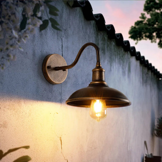 Outdoor bronze sconce casting downward pool of light on terrace