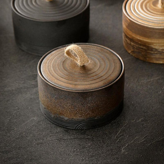 Stoneware storage jar with matte earth tone finish and rope loop