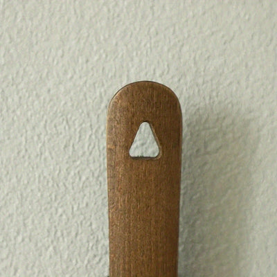 Wooden shoehorn handle detail showing sanded finish
