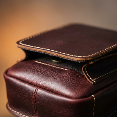 Close-up of full-grain leather texture stitching and magnetic flap on waist pack