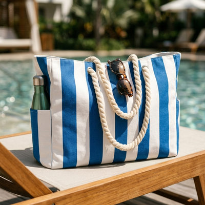 Blue beach tote on pool deck lounge chair with water bottle in side pocket