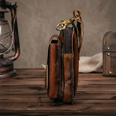Dark brown leather waist pack magnetic flap open showing quick access pocket
