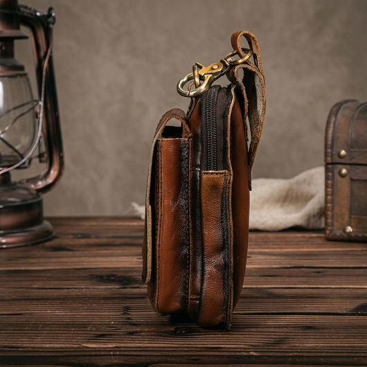 Dark brown leather waist pack magnetic flap open showing quick access pocket