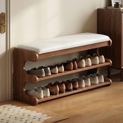 Walnut brown bamboo shoe storage bench with white cushion in entryway with shoes on two shelves