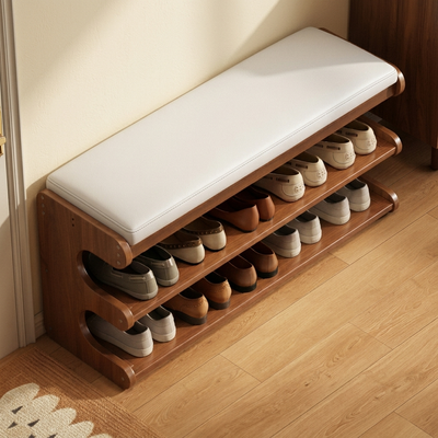 Overhead view of brown bamboo shoe bench with white padded seat and organized shoe shelves