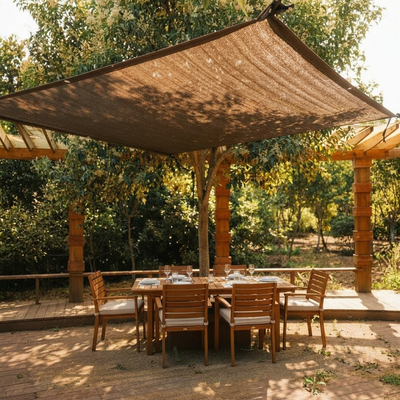 Brown shade cloth over backyard deck dining table with dappled shade