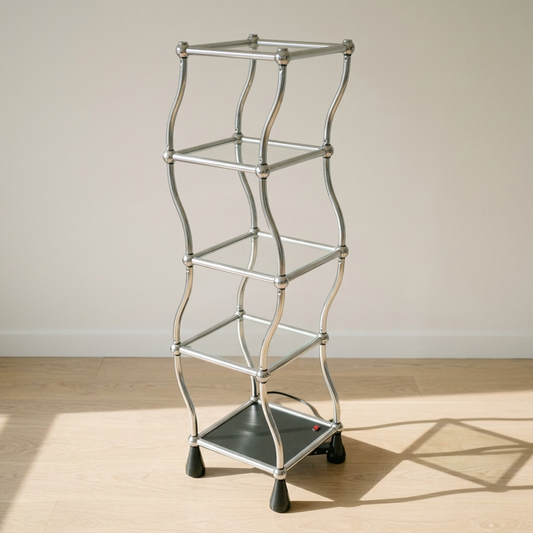 Silver motorized rotating display shelf against a white wall