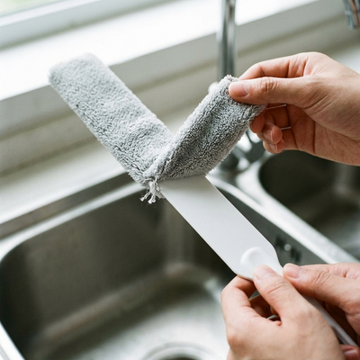 Microfiber sleeve being pulled off the duster head for washing
