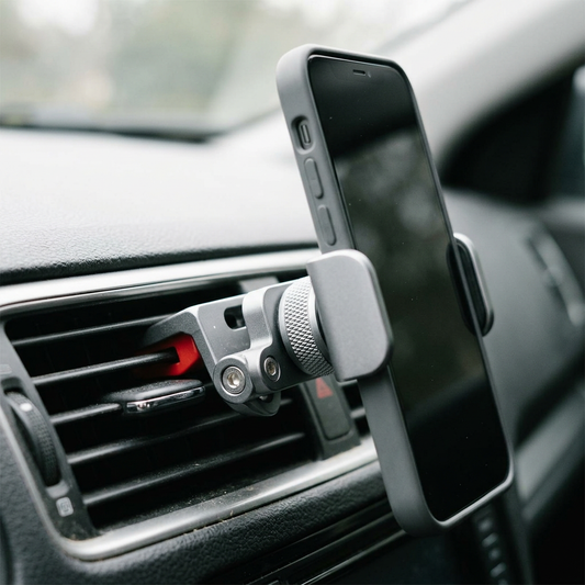 Silver vent clip mount holding a phone on a car air vent