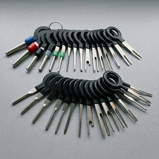 Terminal removal keys laid out on a workbench showing the range of blade widths